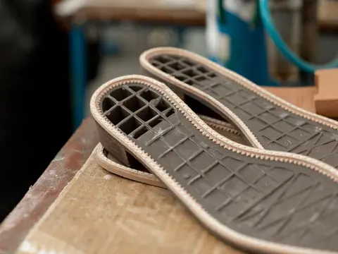 Shoe soles and insole blanks on a workshop bench