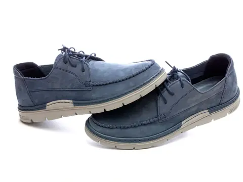 A pair of blue leather lace-up walking shoes on a white background